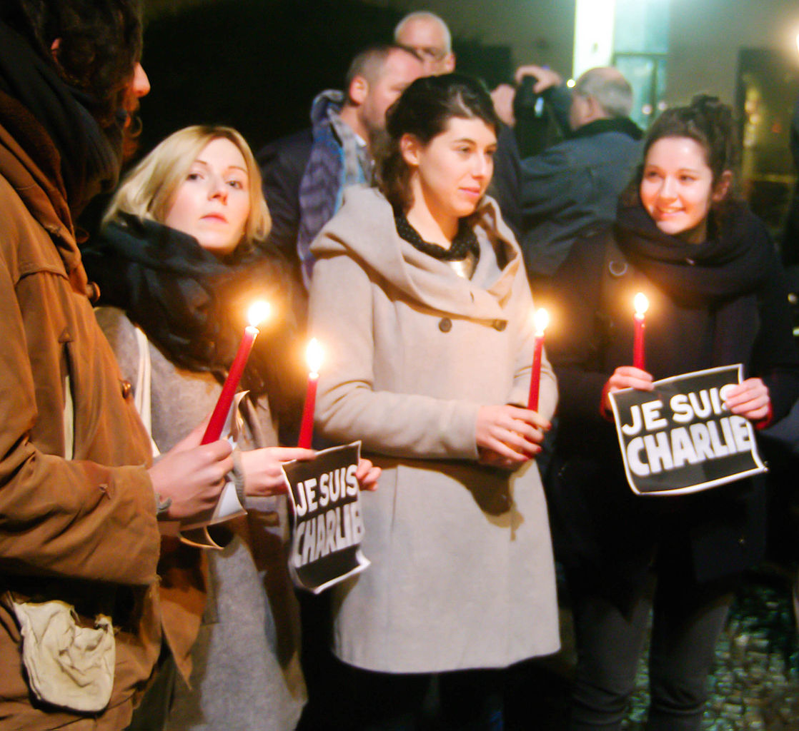 Auf dem Bild sind Menschen mit Kerzen zu sehen. Sie Gedenken an den Anschlag auf Charlie Hebdo